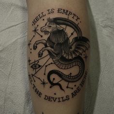 a black and white photo of a tattoo on someone's leg that says hell is empty