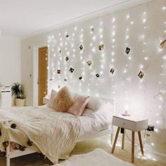 a bedroom decorated with lights and pictures on the wall above the bed, along with other decorations