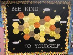 a bulletin board with bee kind written on it and some words in different languages below