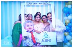 a group of people standing next to each other in front of a birthday photo frame