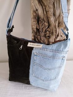 two pieces of denim are sitting next to each other on a white surface with a tree trunk in the background