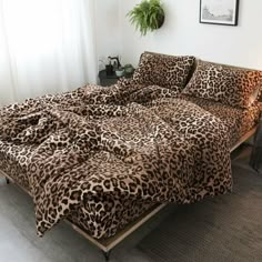 a leopard print comforter set on a bed