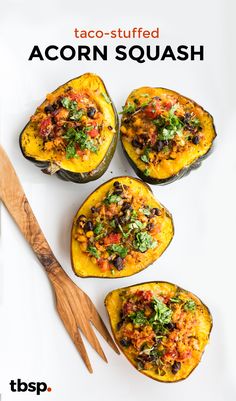 four stuffed acorn squash on a white surface with text overlay that reads taco - stuffed acorn squash