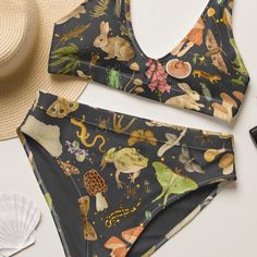 It's too easy to fall in love with this bikini set. Removable pads and its double-layer make it comfy to wear all day by the pool or at the beach. * Fabric composition in the EU: 88% recycled polyester, 12% elastane * Fabric weight in the EU (may vary by 5 6.78 oz/yd² (230 g/m²) * Fabric composition in MX: 81% REPREVE recycled polyester, 19% LYCRA XTRALIFE  * Fabric weight in MX (may vary by 5 7.52 oz/yd² (255g/m²) * Double-layered and non-reversible * Removable padding * Tear-away care label * Zig-zag stitching * Blank product components in the EU sourced from Spain, Germany, Taiwan, Vietnam, Cambodia, and Lithuania * Blank product components in MX sourced from Colombia, Taiwan, and China Beach Fabric, Cottagecore Shirt, Night Forest, Boho Shirts, Cute Swimsuits, Pretty Lingerie, Art Shirts, Dark Forest, Sustainable Clothing