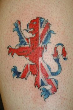 a british flag tattoo on the back of a woman's thigh, with a lion