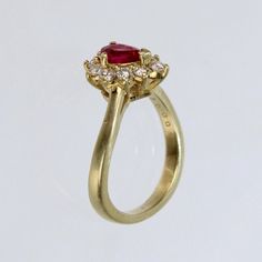 A wonderful cocktail ring by Kurt Wayne.  In 18K yellow gold with a half-twist to the shank. The shank supports a gallery with a central pear-cut ruby and 10 small round cut diamonds.   A high-level ring from the famous New York jewelry designer!  Marked to the shank 750 for 18k gold fineness and with a conjoined KW for Kurt Wayne.  Ring Size: ca. 5 1/2  Dimensions reference the ring size and are not specific to the ring itself. Classic Ruby Ring With Pear-shaped Stone, Yellow Gold Pear-shaped Ruby Ring, Pear-shaped Ruby Ring With Diamond Halo Setting, Pear-shaped Ruby Ring With Diamond Halo, Classic Pear-shaped Ruby Ring, Teardrop Yellow Gold Ruby Ring For Wedding, Classic Pear-shaped Brilliant Cut Ruby Ring, Pear-shaped Gold Ruby Ring With Diamonds, Pear-shaped Ruby Diamond Ring In Gold