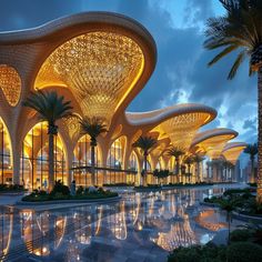 an artisticly designed building with palm trees in the foreground and water reflecting on the ground