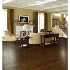 a living room filled with furniture and a fire place next to a stair case in front of a fireplace