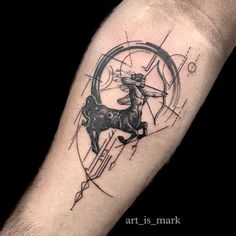 a man's arm with a horse and compass tattoo on it