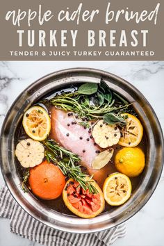 an apple cider brined turkey breast in a pot with herbs and oranges