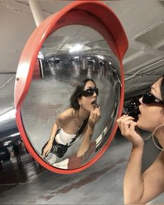 a woman brushing her teeth in front of a mirror