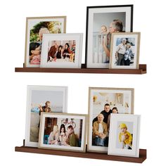 three wooden shelves with pictures on them and one shelf holding two framed photos in it