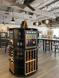 a wine rack in the middle of a room with tables and stools around it