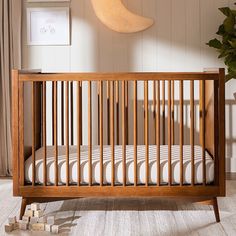 a wooden crib in the corner of a room