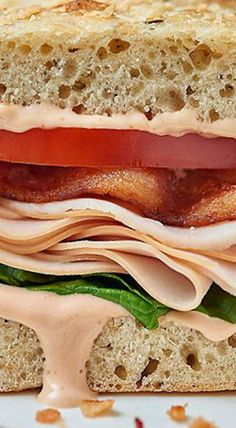 a sandwich with bacon, lettuce and tomato