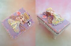 there is a small box with a little angel on it and the other one has a doll in it