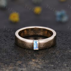 a gold ring with a blue stone in the middle