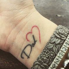 a tattoo on the wrist of a woman with a heart and an arrow in it