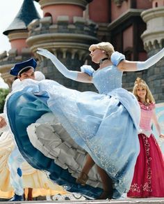 some people are dressed up like disney princesses and one is wearing a blue dress