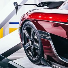 the front end of a red sports car on display