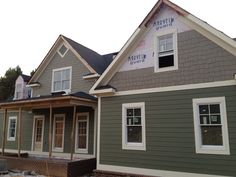 a house being built with siding and windows