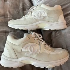 Pre-Loved White Chanel Sneakers. Only Worn A Handful Of Times. Great Condition As Can See From Photos, Couple Of Small Marks But Only Really One On Front Of Left Shoe Which Is Not Overly Noticeable, Could Look To Get Them Professionally Cleaned If Wanted To. Complete With Dust Bags. 100% Authentic. Thanks :) Elegant White High-top Sneakers, Elegant Cream Low-top Sneakers, White Chanel Sneakers, Shoes Chanel, Chanel Sneakers, Cc Logo, Chanel Shoes, Womens Shoes Sneakers, Low Top