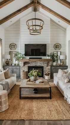 a living room filled with furniture and a flat screen tv mounted on the wall above a fire place