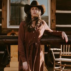 With a rich tobacco color and authentic Western-inspired design, this long-sleeve, mid-length dress features one-point front and back yokes, a full-front snap placket, and curved snap cuffs. It has a self-tie belt with belt loops, two smile pockets and two two side seam pockets. Made from sustainable Tencel twill, it pairs equally well with a cowboy hat and boots as it does with a sun hat and sandals. Single Point Front And Back Yokes Smile Pockets Curved Snap Cuffs Side Seam Pockets Full Front Brown Cowboy Hat, Cute Cowgirl Outfits, Modern Farmer, Two Two, Western Dress, Wide Trousers, Cowgirl Outfits, Outfits With Hats, Western Dresses