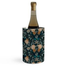 a bottle of wine in a flowered cup