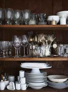 a shelf filled with lots of glassware and silverware