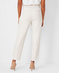 Elevate your wardrobe with the Ann Taylor Side Zip Ankle Pant in Fluid Crepe, tailored to flatter with a curvy fit. These pants are a modern essential for any fashion-forward woman.

- **Size:** 0
- **Color:** Ivory Whisper
- **Material:** 95% Polyester, 5% Spandex
- **Fit:** Tailored and fitted, curvy fit
- **Leg Shape:** Slim, slightly cropped to hit at the ankle
- **Rise:** High rise, sits 1/2" to 1" below natural waist
- **Length:** 27" inseam with a 14 1/4" leg opening
- **Closure:** Side z Petite Curvy, Lean Legs, Knitted Suit, Chic Pants, Tailored Design, Ankle Pants, Slim Fit Pants, Slim Leg, Waist Length