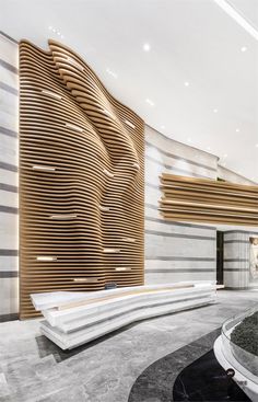 an artisticly designed lobby with marble and wood accents