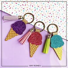 three ice cream keychains with glitter on them