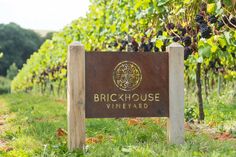 brickhouse vineyard sign in front of rows of vines