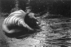 black and white photograph of a woman in the water with her head above the water's surface