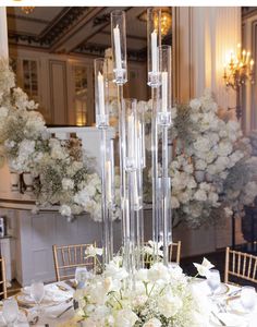 an elegant centerpiece with white flowers and candles