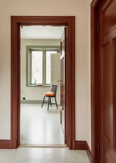 an open door leading to a room with a chair