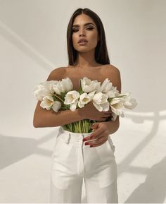 a woman holding flowers in her hands