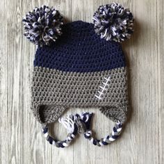 a crocheted hat with two pom poms