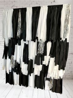 black and white clothes hanging on a brick wall