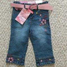 Paris Blues Capri Length Denim Pants With Embroidered Flowers With Buttons Sewn On In Glorious Detail. Comes With Pink Belt. Adjustable Waist. Cute Spring Denim Pants, Cute Embroidered Blue Bottoms, Cute Embroidered Spring Jeans, Blue Embroidered Spring Pants, Cute Blue Embroidered Jeans, Cute Embroidered Denim Bottoms, Cute Pink Denim Jeans, Cute Embroidered Blue Jeans, Embroidered Denim Blue Pants