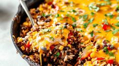 a skillet filled with mexican rice and beans