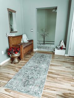 a large rug is in the middle of a room with blue walls and wooden floors