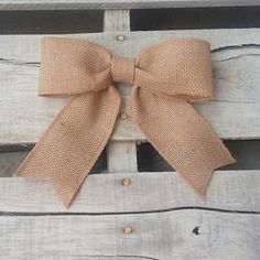 a brown bow sitting on top of a wooden bench