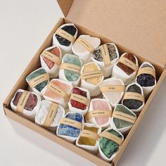 a box filled with lots of different colored stones