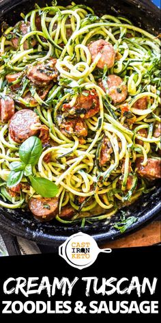 a skillet filled with zucchini noodles and sausage