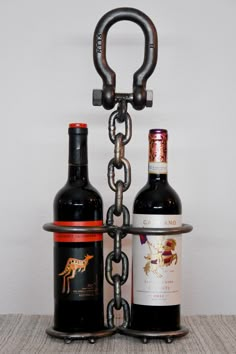 two bottles of wine are chained to each other by a bottle holder with a chain