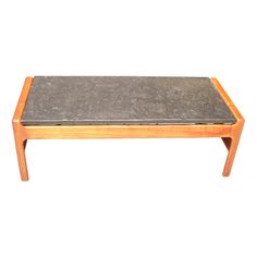 a wooden table with a stone top on it's legs, against a white background