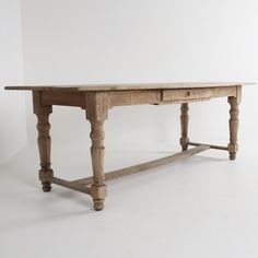 an old wooden table with two drawers on one side and turned over to the other