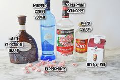 an assortment of liquor bottles and candy canes on a marble counter top with words describing them